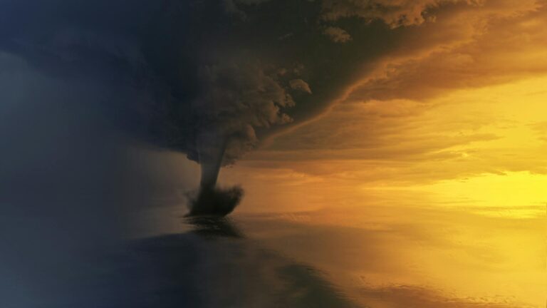 A powerful tornado over the ocean during a dramatic sunset, capturing the storm's intensity and beauty.